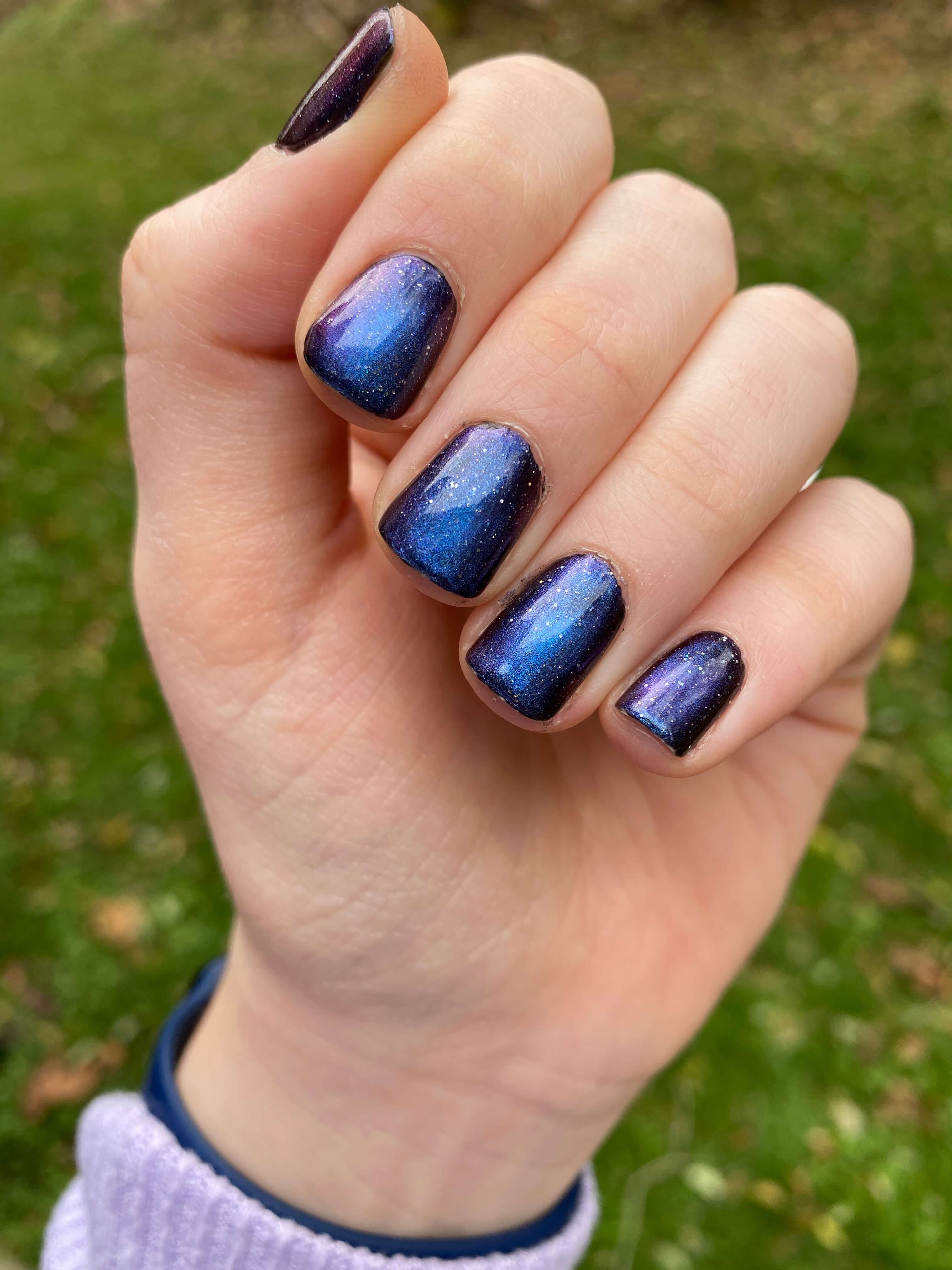 Rebekah's nails with galaxy polish. Her nails are short and not messy.