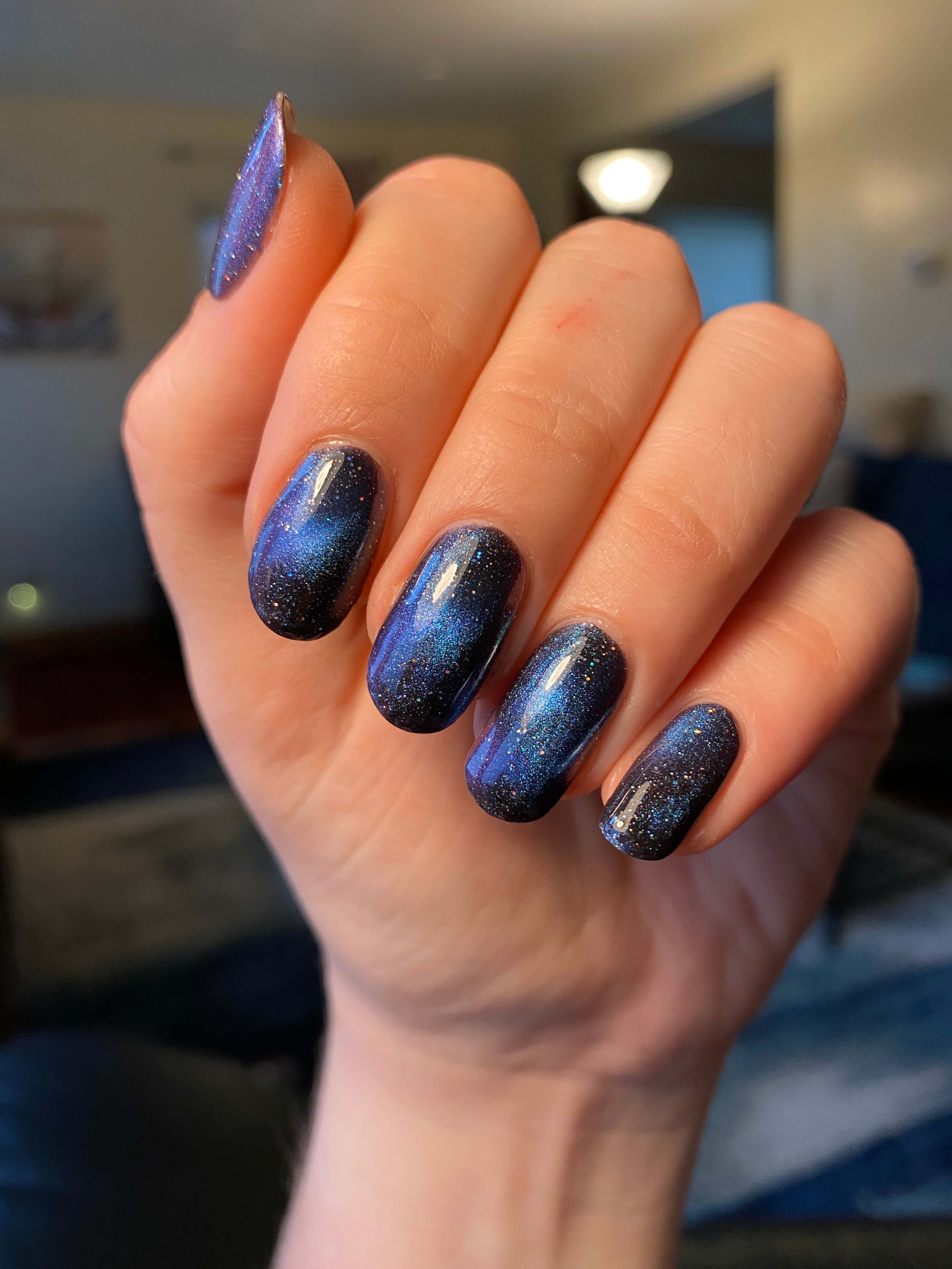 Rebekah's nails with galaxy polish. Her nails are longer, and it looks like the actual Milky Way is at her fingertips.