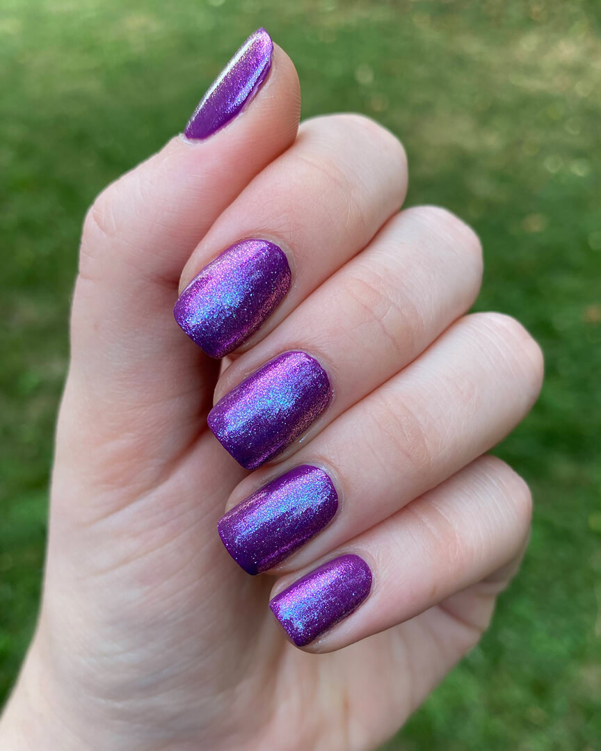 Rebekah is wearing a purple nail polish with a blue iridescent shimmer