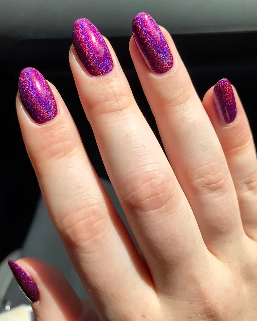 Rebekah is wearing a holographic magenta nail polish