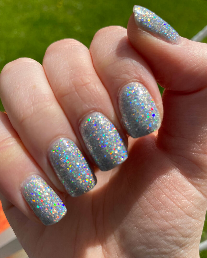 Rebekah is wearing a silver glittery holographic nail polish