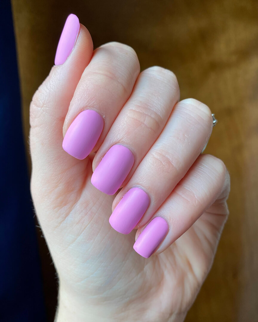 Rebekah is wearing a bubblegum pink nail polish with a matte finish