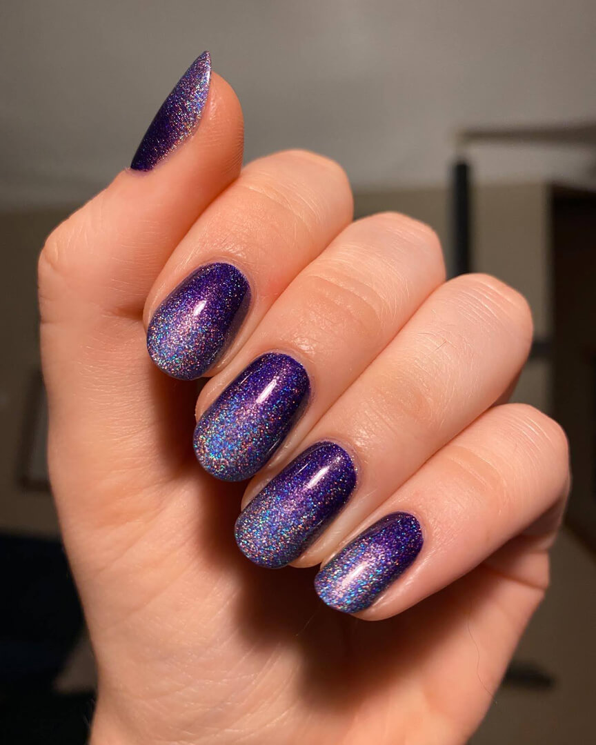 Rebekah is wearing a gradient of a darker and lighter holographic nail polish